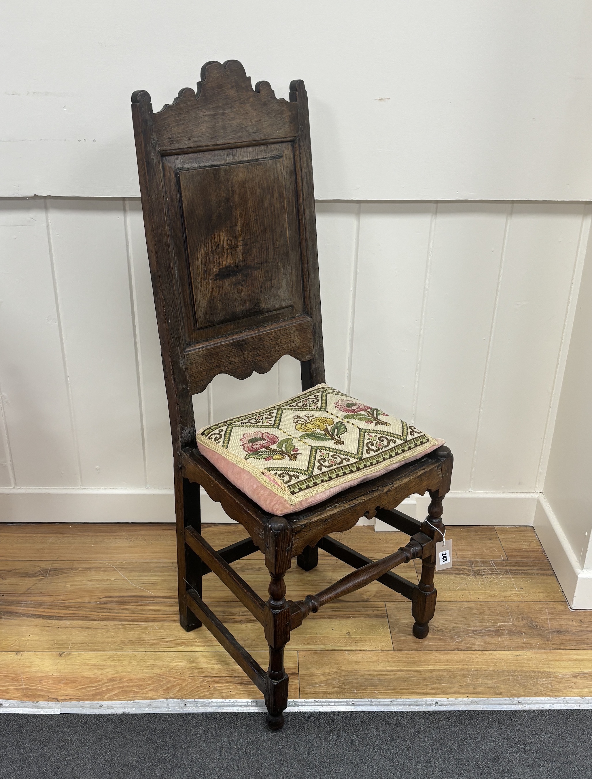 A William III oak backstool, late 17th century, width 44cm, depth 38cm, height 140cm